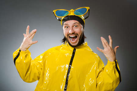 Man wearing yellow suit in funny conceptの写真素材