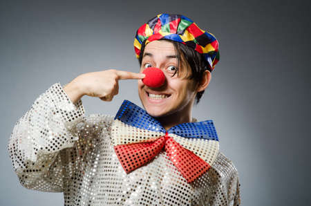 Funny clown against dark backgroundの写真素材