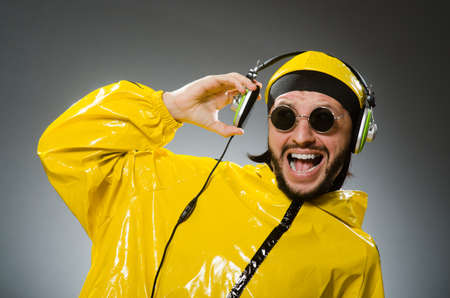Man wearing yellow suit listening to headphonesの写真素材