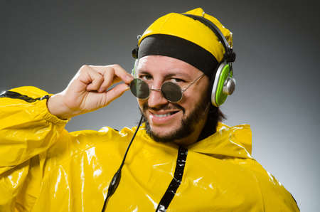 Man wearing yellow suit listening to headphonesの写真素材
