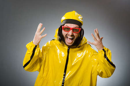 Man wearing yellow suit in funny conceptの写真素材