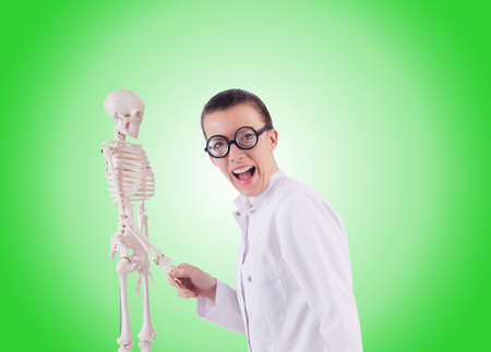Doctor with skeleton against gradientの写真素材