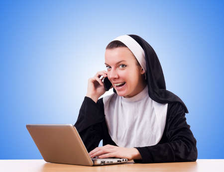 Nun working on laptop - religious conceptの写真素材