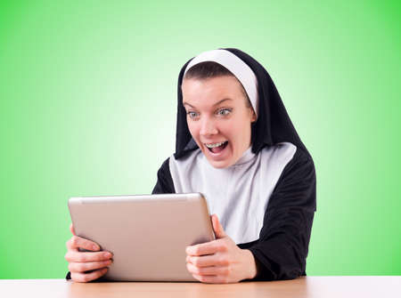 Nun working on laptop - religious conceptの写真素材