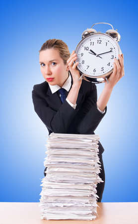 Woman businesswoman with giant alarm clockの写真素材