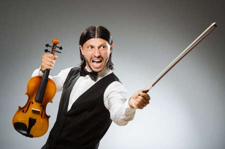 Man playing violin in musical conceptの写真素材