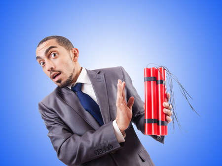 Businessman with dynamite against the gradientの写真素材