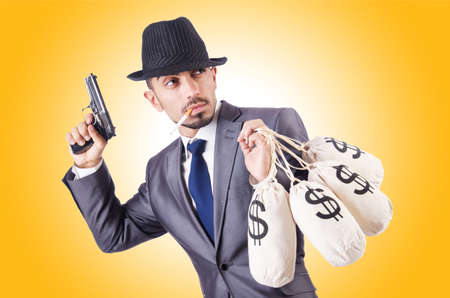 Businessman criminal with sacks of moneyの写真素材