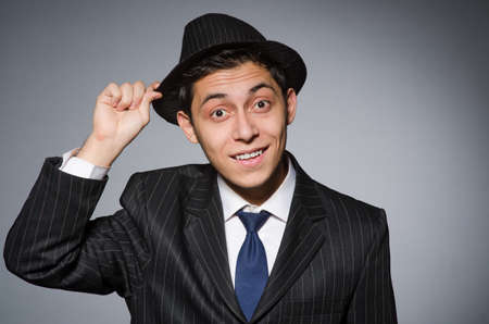 Young man in classic striped costume and hat isolated on grayの写真素材