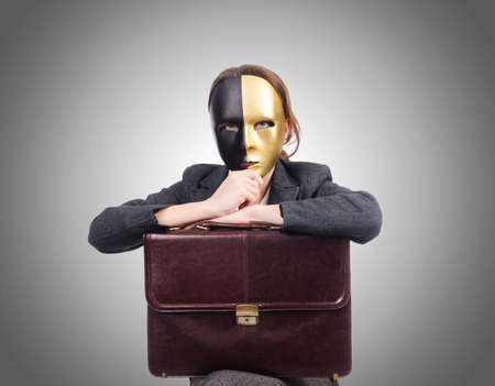 Woman with mask in hypocrisy conceptの写真素材