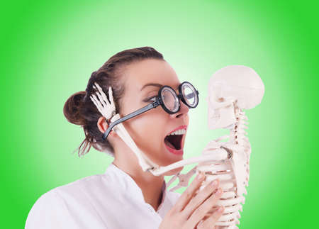 Doctor with skeleton against gradientの写真素材