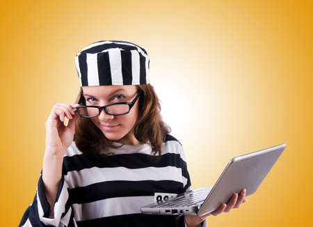 Criminal hacker with laptop against gradientの写真素材