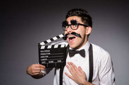 Young man with false moustache isolated on grayの写真素材