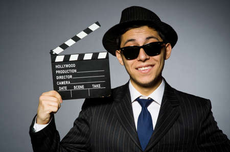Young man in classic striped costume and hat isolated on grayの写真素材