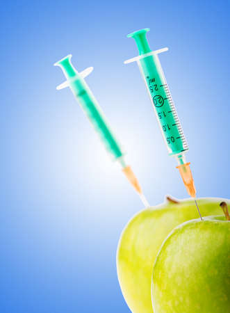 Experiment with apple and syringesの写真素材