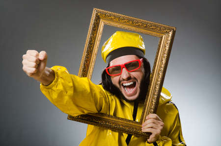 Man wearing yellow suit with picture frame
