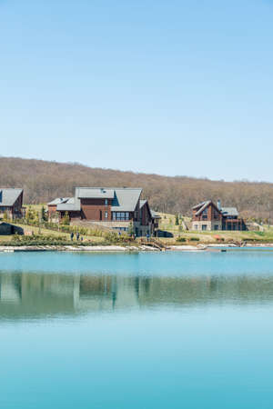Modern house near water on bright dayの写真素材