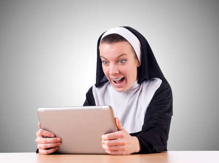 Nun working on laptop - religious conceptの写真素材