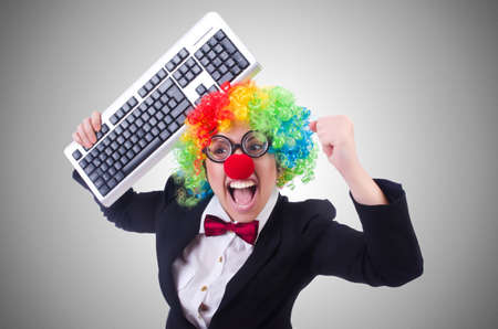 Funny clown with keyboard on whiteの写真素材