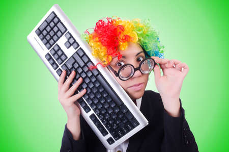 Funny clown with keyboard on whiteの写真素材