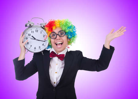Funny clown with clock on whiteの写真素材