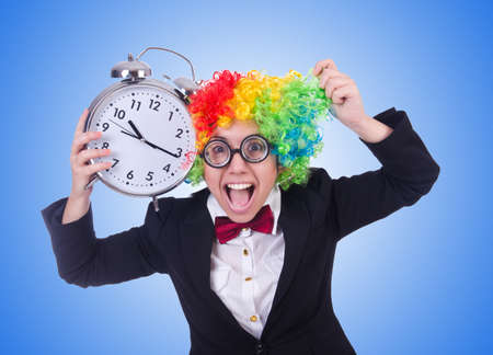 Funny clown with clock on whiteの写真素材