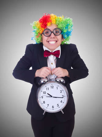 Funny clown with clock on whiteの写真素材