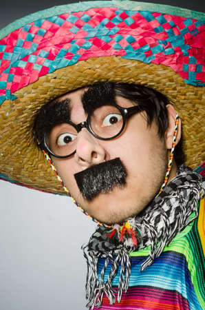 Man in vivid mexican poncho against grayの写真素材