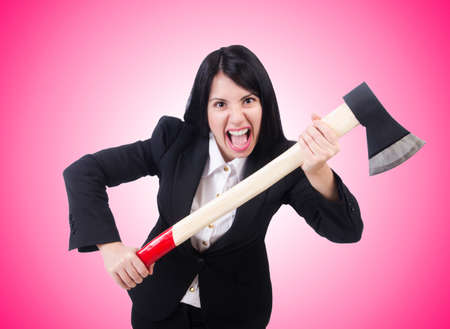 Angry businesswoman with axe on whiteの写真素材