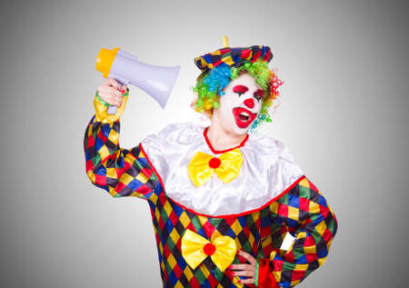 Clown with loudspeaker on white