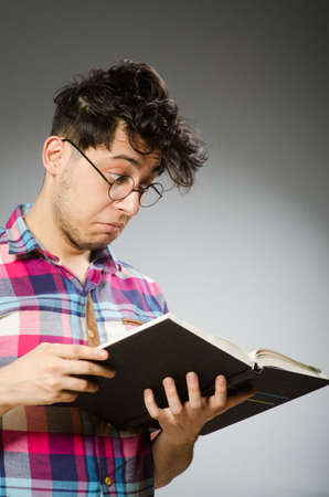 Funny student with many booksの写真素材