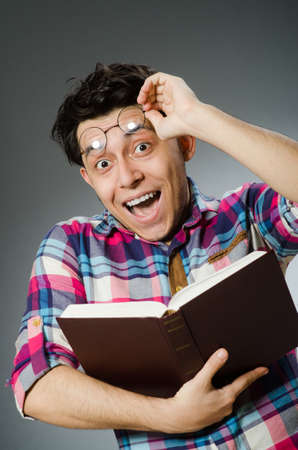 Funny student with many booksの写真素材