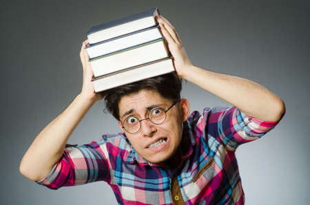 Funny student with many booksの写真素材