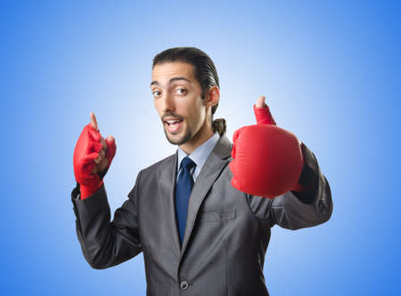 Handsome businessman with boxing glovesの写真素材