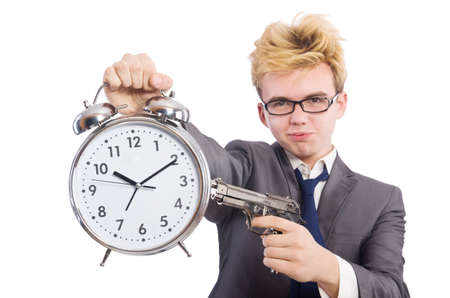 Young businessman holidng gun and alarm clock isolated on whiteの写真素材