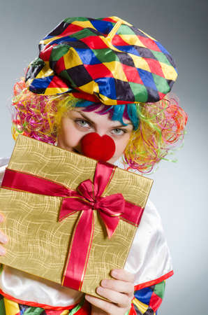 Clown with giftbox in funny conceptの写真素材