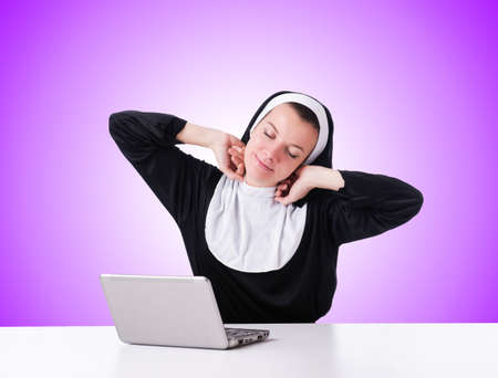 Nun working on laptop - religious conceptの写真素材