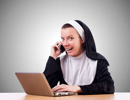 Nun working on laptop - religious conceptの写真素材