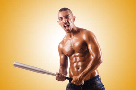 Muscular man with baseball batの写真素材