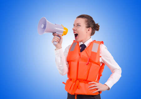 Young woman with vest and loudspeaker on whiteの写真素材
