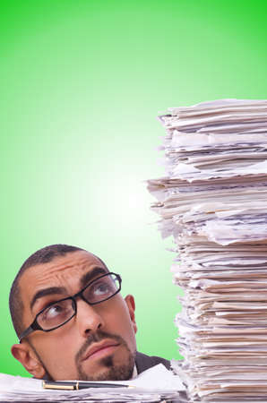 Busy businessman with lots of papersの写真素材