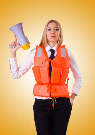 Young woman with vest and loudspeaker on whiteの写真素材