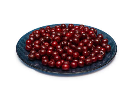 Plate full of cherries isolated on whiteの写真素材