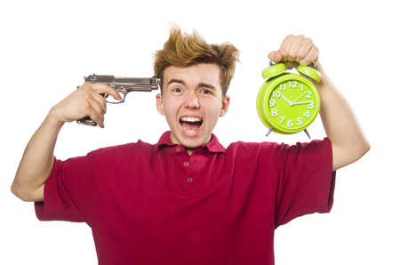 Student holding alarm clock and handgun isolated on whiteの写真素材