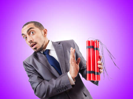 Businessman with dynamite against the gradientの写真素材