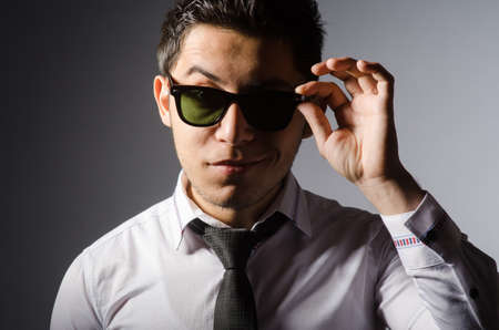 Young caucasian man against grayの写真素材