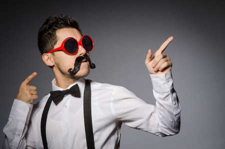 Young caucasian man against grayの写真素材