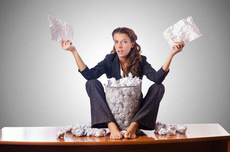 Woman with lots of discarded paperの写真素材
