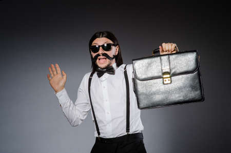 Man with moustache and sunglasses against grayの写真素材