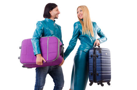 Pretty girl and man holding suitcases isolated on whiteの写真素材